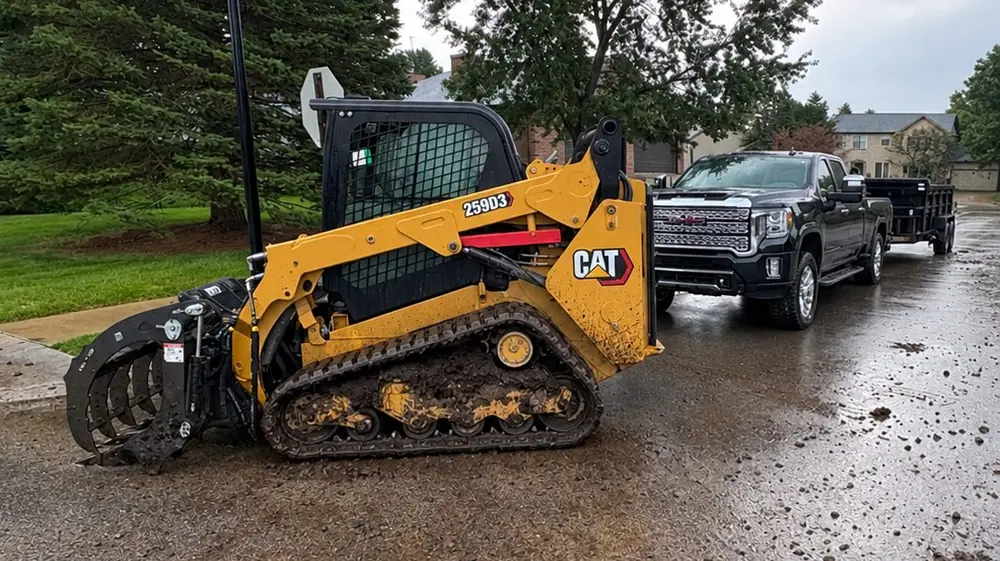 Bauer Landscape CAT compact track loader and work truck on a job