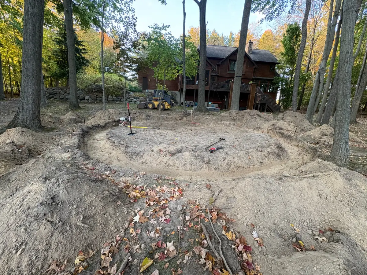 Backyard excavated for a new circular paver patio